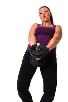 Young beautiful red-haired fitness female have fun with dumbbell, isolated on white background