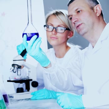 two scientist in chemical lab conducting experiments