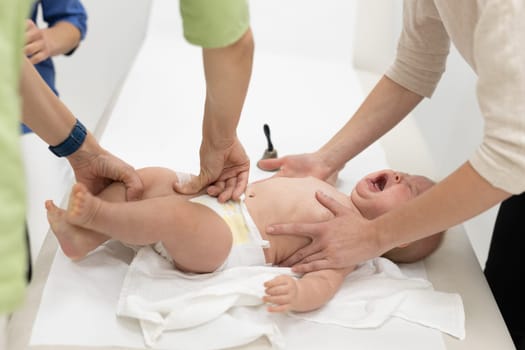 Baby beeing vaccinated by pediatrician in presence of his mother. Preventive vaccination against Diphtheria, whooping cough, tetanus, hepatitis, haemophilus influenzae, pneumococcus, poliomyelitis.