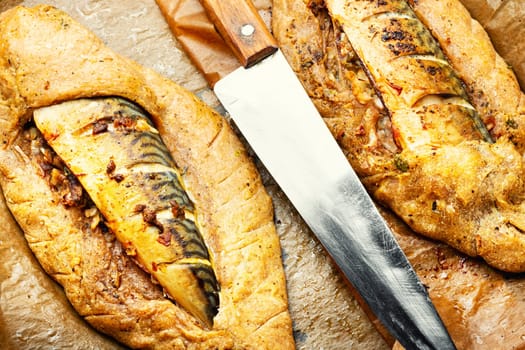 Delicious fish pie with mackerel on on baking paper. Fish baked in bread.
