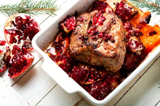 Tasty piece of pork meat baked with pomegranate. Recipes for Christmas.
