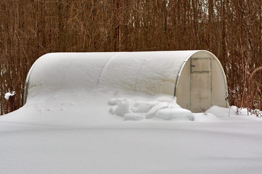 glass greenhouse covered with snow. High quality photo