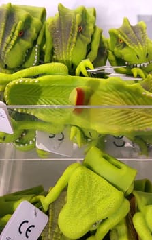 Close-up of toy dinosaurs on store shelves.