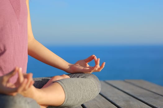 Close up of yogi hands doing yoga exercise on the beach