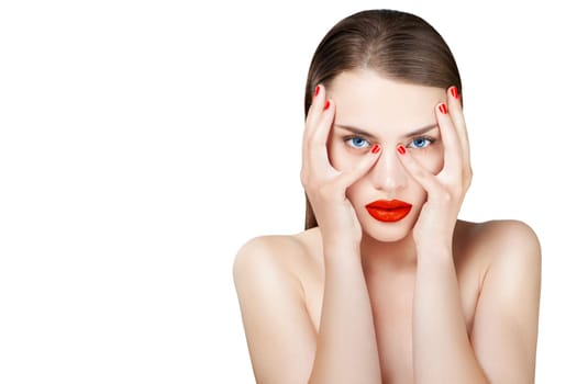Hot young female model with sexy red lips makeup, strong eyebrows, clean shiny skin, red bright fingernails and blue eyes. Luxury fashion style, manicure, cosmetics and make-up.