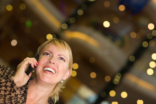 Beautiful Blonde Woman On Her Cell Phone in the City Lights.