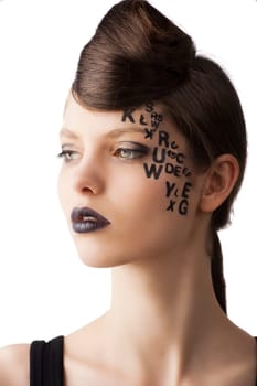 very cute young girl with letter and number painted on her face and a nice creative hair style, she is turned of three quarters at right and looks in front of her