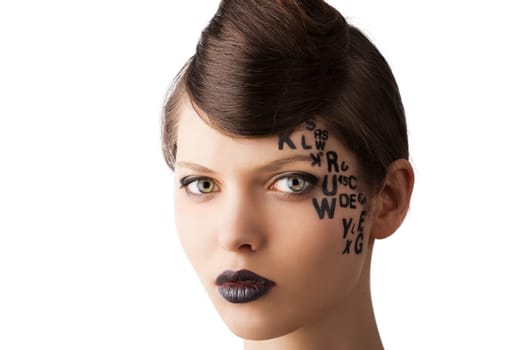 very cute young girl with letter and number painted on her face and a nice creative hair style, she looks in to the lens