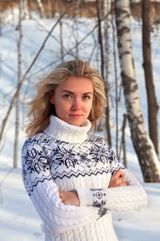 Beautiful young woman in winter clothes outdoor in forest