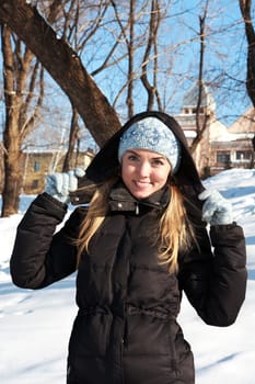 Beautiful young woman in winter clothes outdoor in forest