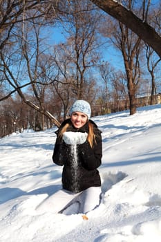 Beautiful young woman in winter clothes outdoor in forest