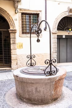 Verona, Italy - July 2022: the famous Well of Love, romantic sightseeing in the heart of the city