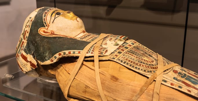 Turin, Italy - March 2023: Egyptian Museum, mummy of a baby with a mask - 2nd Century BC
