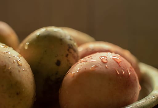 Freshly washed mangoes on bowl with copy space, Concept of fresh mangoes in a basket with water splash, Ripe mangoes with water drops on bowl