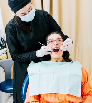 Dentist performing dental checkup, Patient checked by dentist, close up of dentist with patient, dentist performing root canal treatment on patient