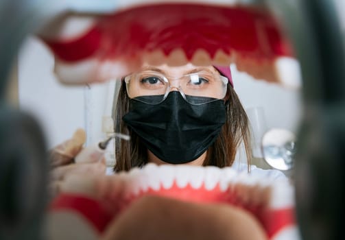 Woman dentist cleaning a mouth inside view, Inside view of a mouth checked by a dentist, a female dentist checking a patient. dentist checking a mouth, a dentist cleaning teeth