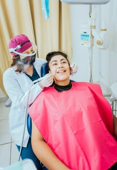 Stomatologist cleaning a patient teeth, Female dentist cleaning a patient's mouth with a drill. Close-up of a stomatologist cleaning a woman teeth, Stomatologist cleaning caries with drill