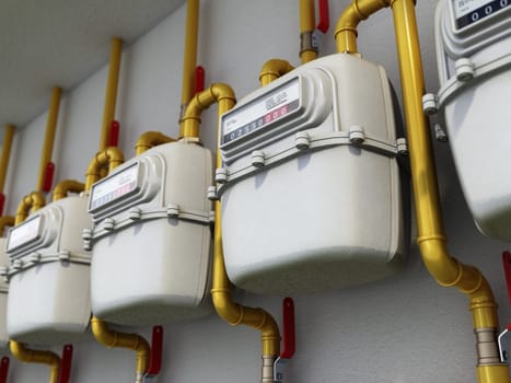 Domestic gas meters in a row. 3D illustration.