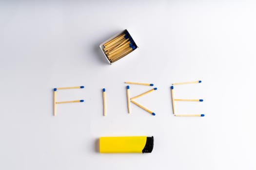 Lighter on a white background including matches box, word FIRE