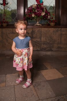 Portrait of 1 year old baby girl in a castle.