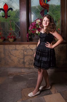 Portrait of a 10 year old girl posing in a castle.