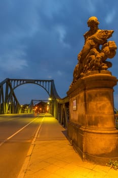 Male statue with fish at the beginning of the Glienicker Bridge