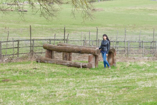 A girl is playing on a wood artefact
