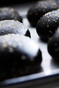 close up of a tray of charcoal buns