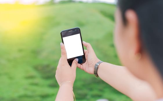 Blank cell phone screen of a girl taking a selfie. Mockup of a person Hand Holding Mobile Phone With Blank Screen And Making Selfie