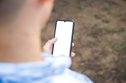 Close up of a man with cell phone in hand, close up shot of a person checking his cell phone, young guy with cell phone in hand with copy space