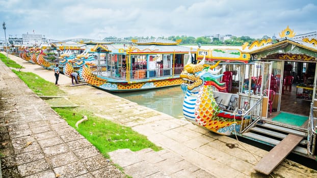Hue, Vietnam, November 17, 2022: Tour boats are parked at the bank of the Perfume River in Hue, Central Vietnam