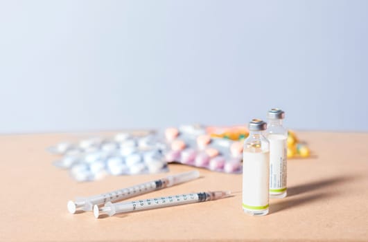 Medicines, pills and syringes on isolated background. Close up of variety of medicines on white background, Concept of addiction to medicines and syringes