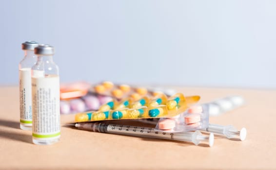 Concept of addiction to medicines and syringes. Concept of inappropriate use of medicines. Medicines, pills and syringes on isolated background, Close up of variety of medicines isolated