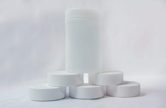 Chlorine tablets for pool cleaning on isolated background. Chlorine tablets for swimming pool disinfection on white background, swimming pool cleaning and maintenance chlorine tablets