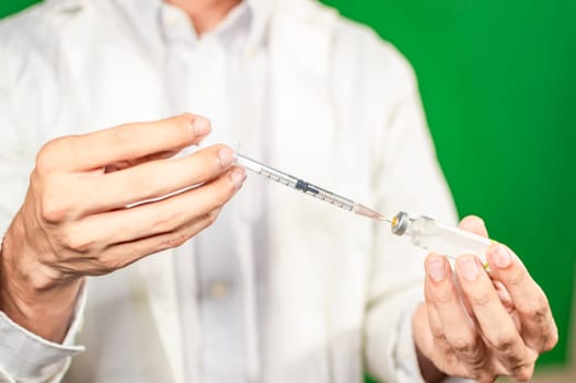 Close up of hands with syringes and capsule, syringe cure concept, doctor hands with syringe