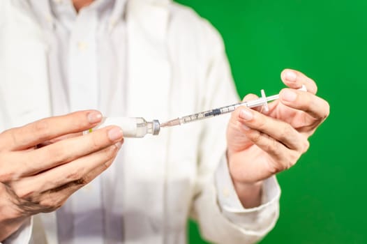 Close up of hands with syringes and capsule, syringe cure concept, doctor hands with syringe