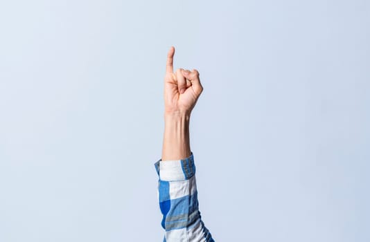 Hand gesturing the letter I in sign language on an isolated background. Man's hand gesturing the letter I of the alphabet isolated. Letters of the alphabet in sign language