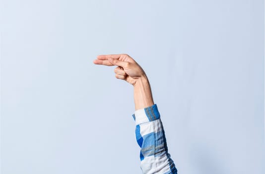Hand gesturing the letter H in sign language on an isolated background. Man's hand gesturing the letter H of the alphabet isolated. Letters of the alphabet in sign language