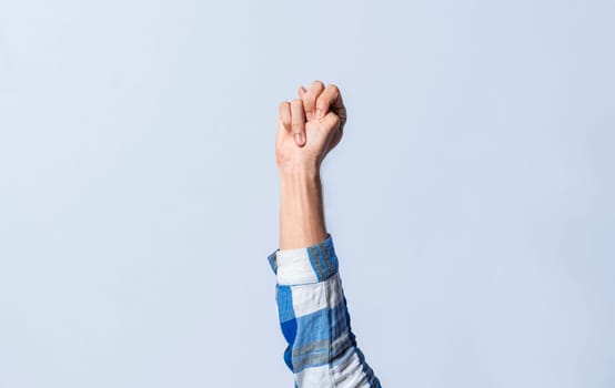 Hand gesturing the letter N in sign language on an isolated background. Man's hand gesturing the letter N of the alphabet isolated. Letter N of the alphabet in sign language
