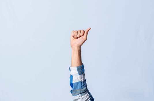 Hand gesturing the letter A in sign language on isolated background. Man hand gesturing the letter A of the alphabet isolated. Letters of the alphabet in sign language.