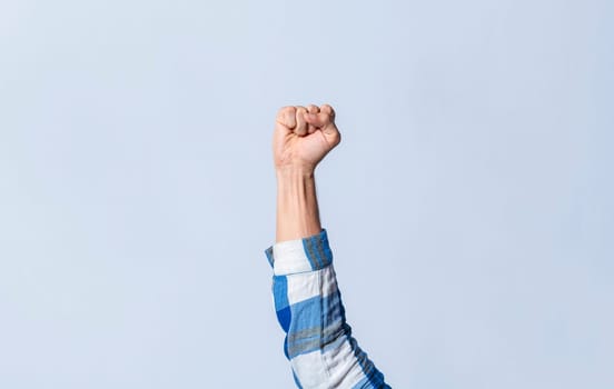 Hand gesturing the letter S in sign language on an isolated background. Man's hand gesturing the letter S of the alphabet isolated. Letter S of the alphabet in sign language