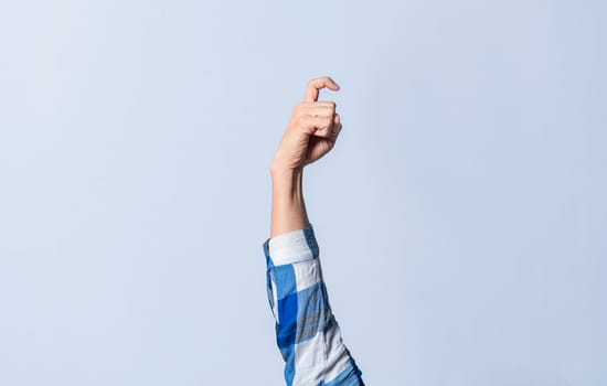 Hand gesturing the letter X in sign language on an isolated background. Man's hand gesturing the letter X of the alphabet isolated. Letter X of the alphabet in sign language