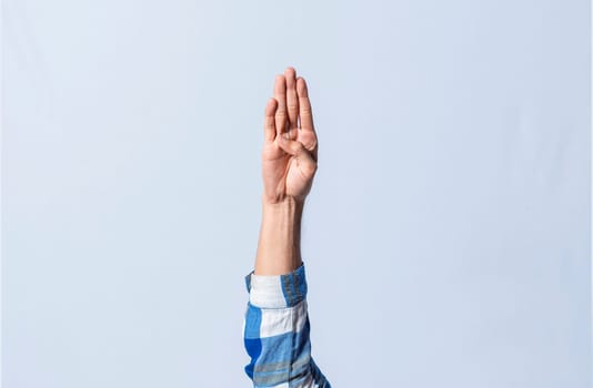 Hand gesturing the letter B in sign language on isolated background. Man hand gesturing the letter B of the alphabet isolated. Letters of the alphabet in sign language