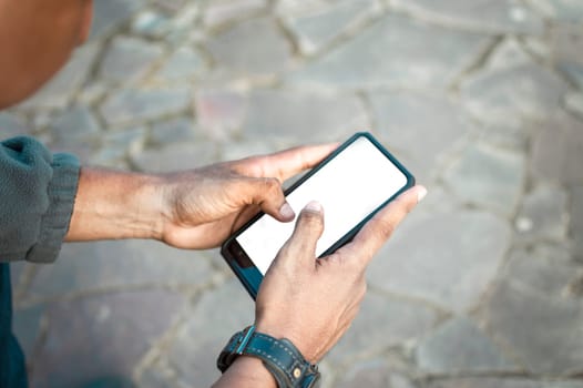 Close up of a man with cell phone in hand, close up shot of a person checking his cell phone, young guy with cell phone in hand with copy space