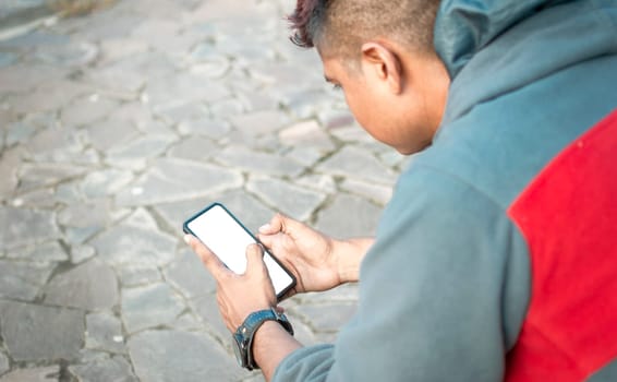 Close up of a man with cell phone in hand, close up shot of a person checking his cell phone, young guy with cell phone in hand with copy space