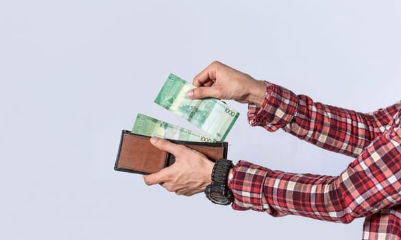 Man taking money out of his wallet, close up of hands taking money out of his wallet isolated, Nicaraguan banknotes, cash payment concept