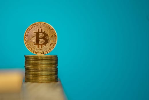 Bitcoin coins with blue background, one gold bitcoin on blue background