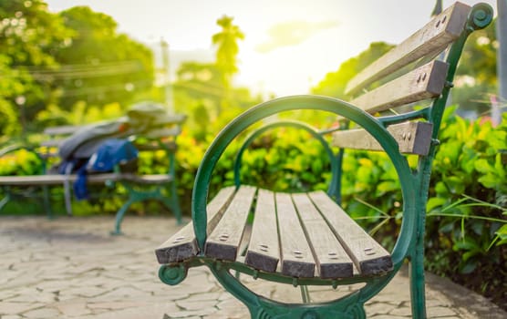 Wooden bench with blur background with copy space. low angle view of a bench in a park, low angle view of a lonely bench in the park with out of focus background