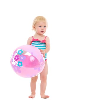 Baby in swimsuit with inflatable beach ball