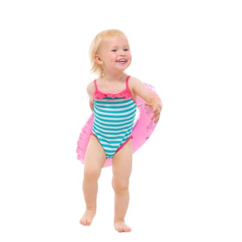 Smiling baby in swimsuit with inflatable ring